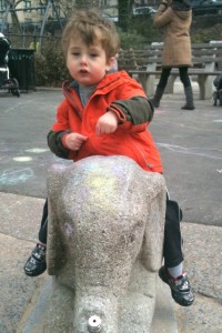 Riding an elephant at the playground